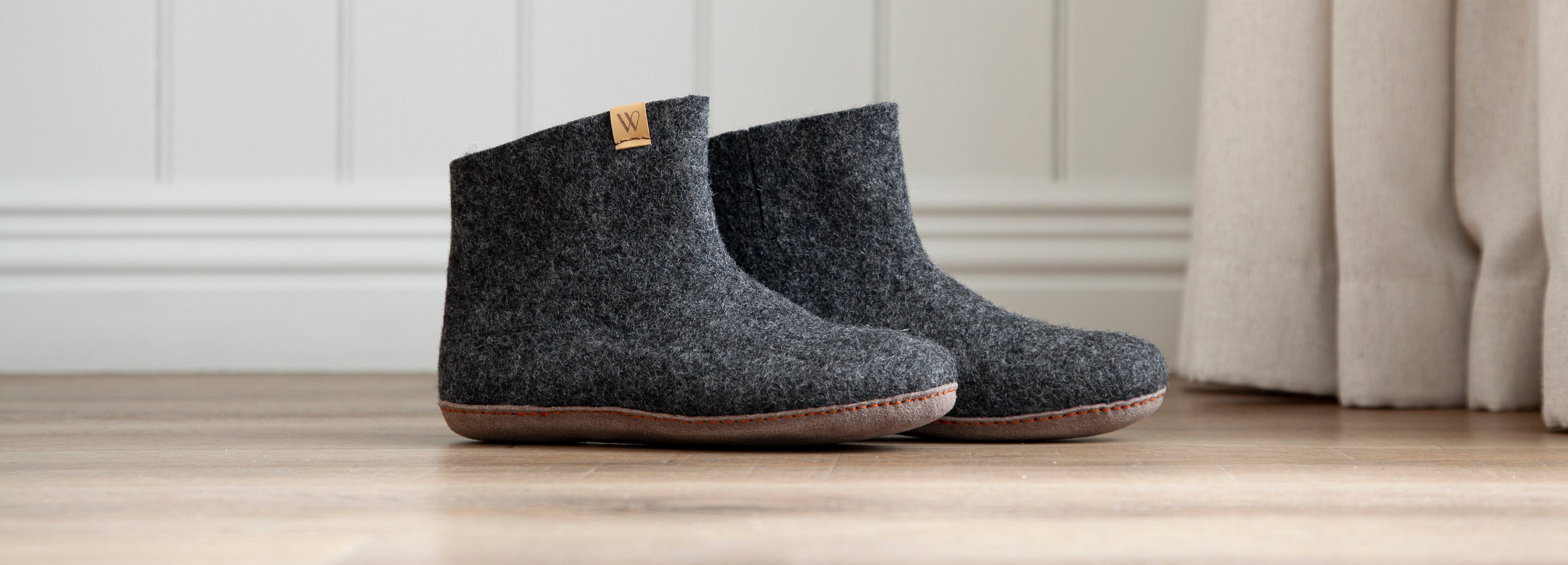 Charcoal Grey New Zealand Wool Boot Slippers with suede sole on hardwood floor